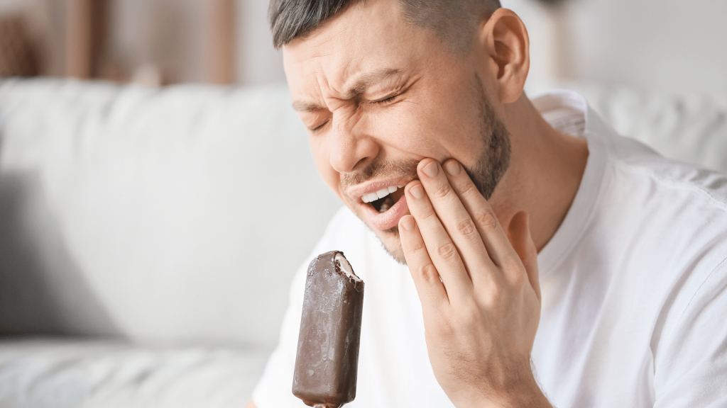 Man eating Chocolate has toothache